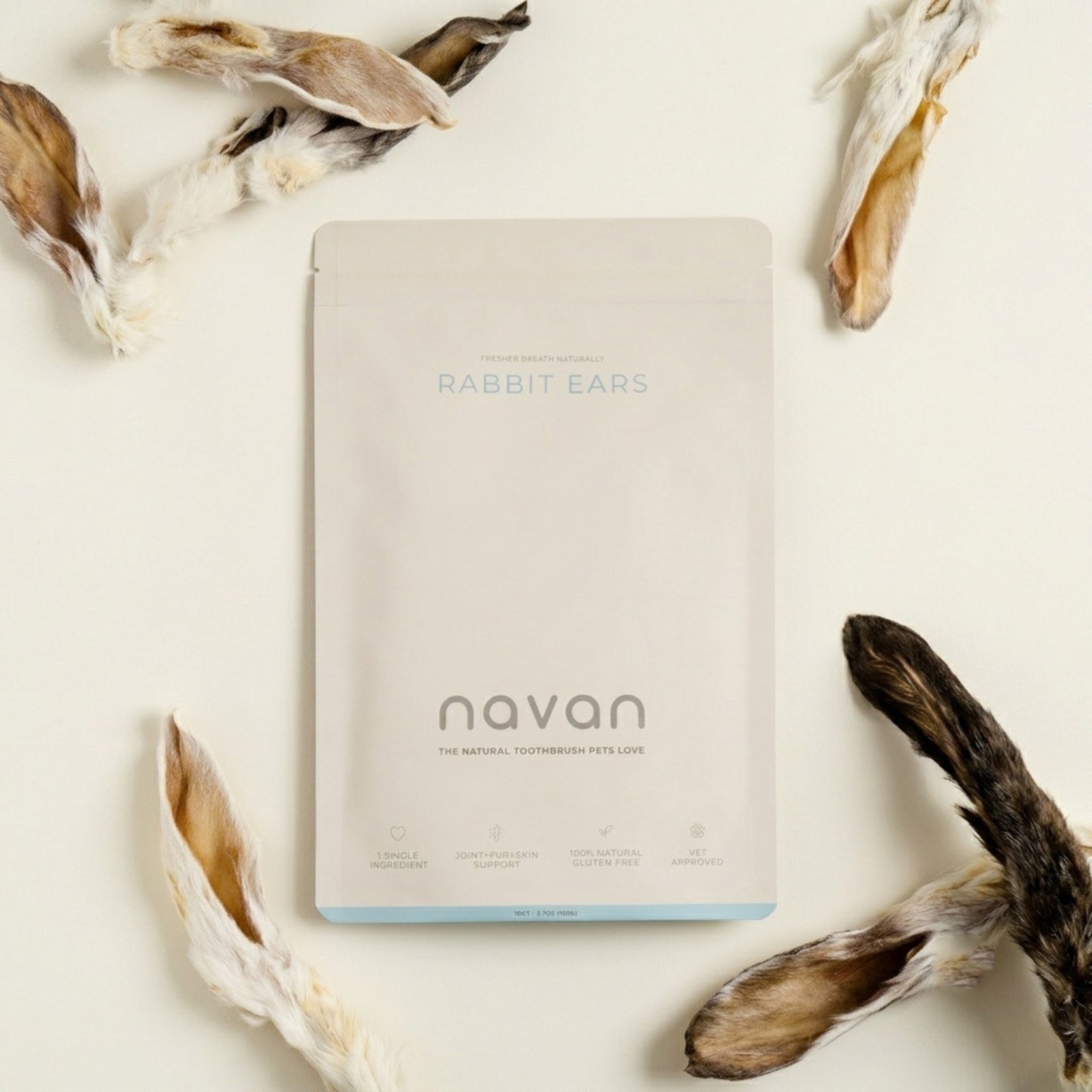 rabbit ears aerial flat-lay — bag with chews scattered